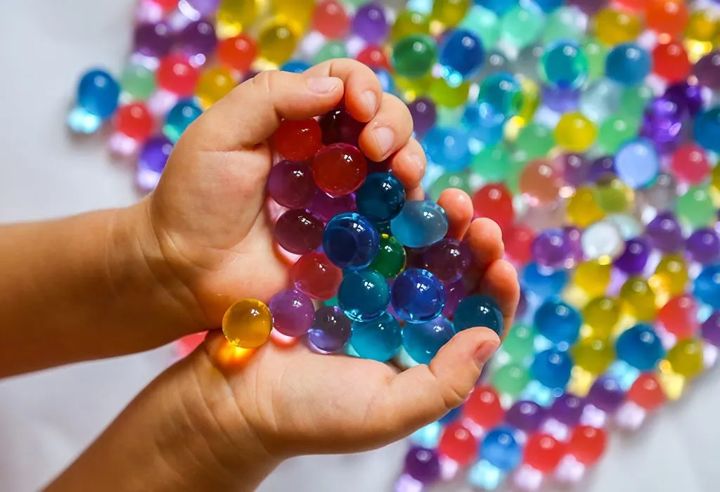 Child playing with water beads