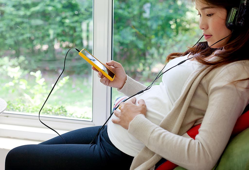 A pregnant woman using a mobile phone
