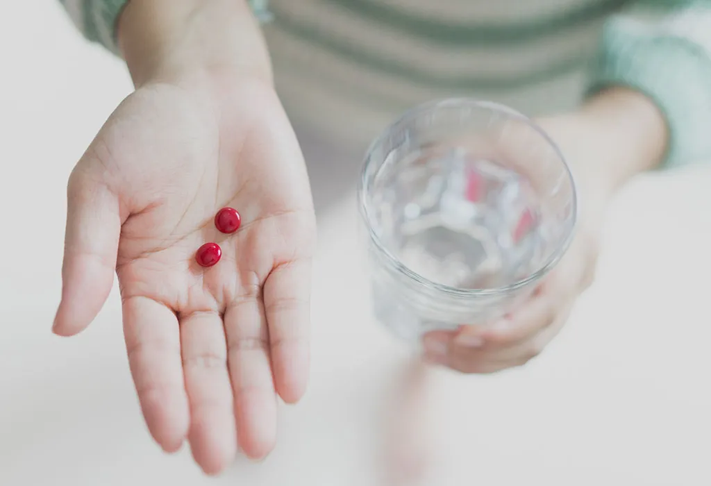 Woman taking iron supplement