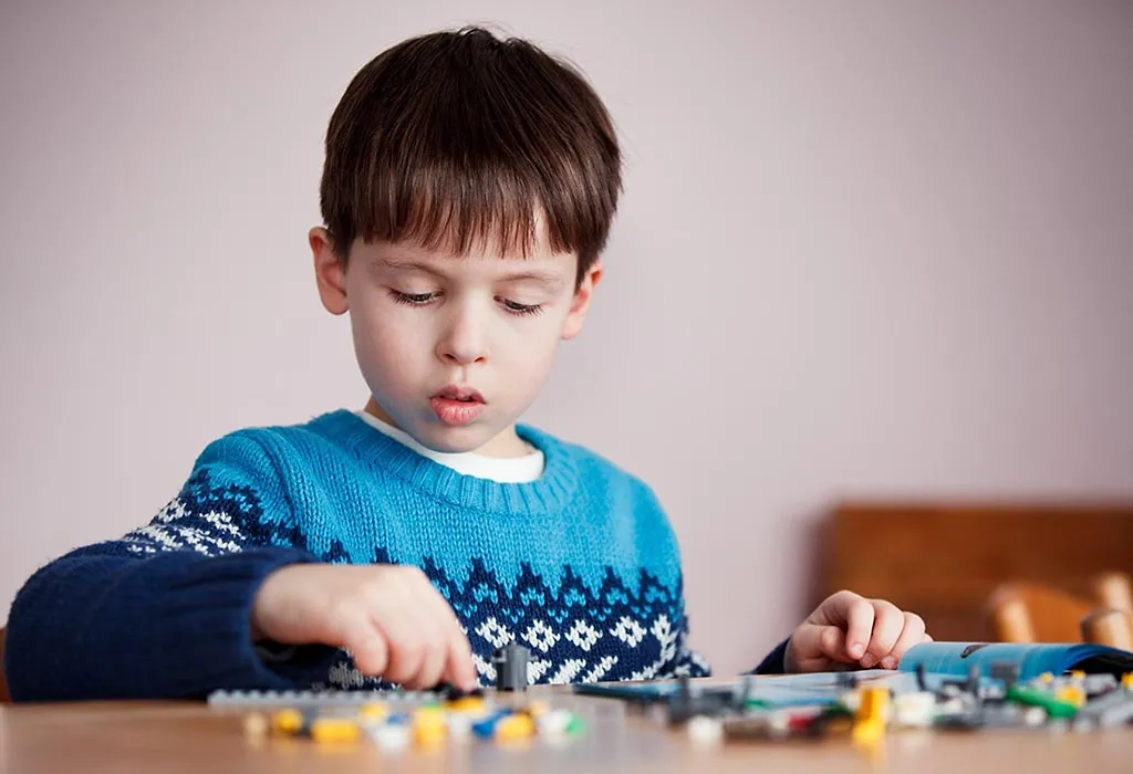 A five-year-old kid playing with blocks