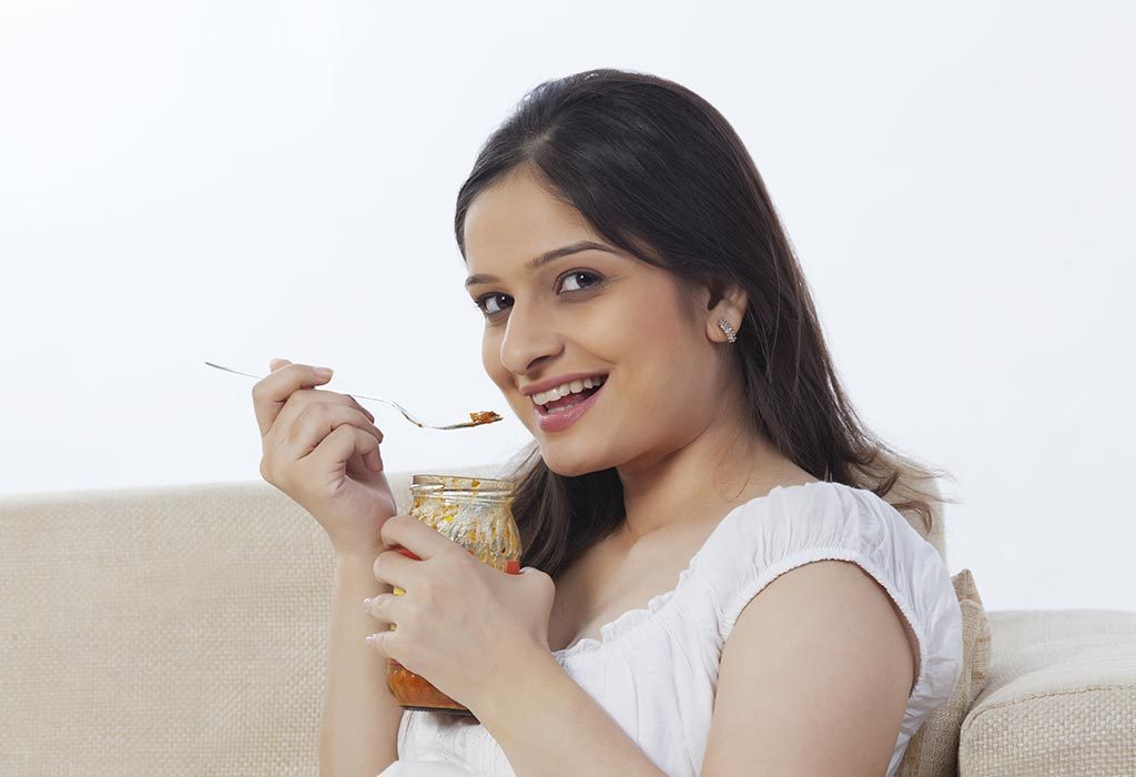 Woman eating a pickle