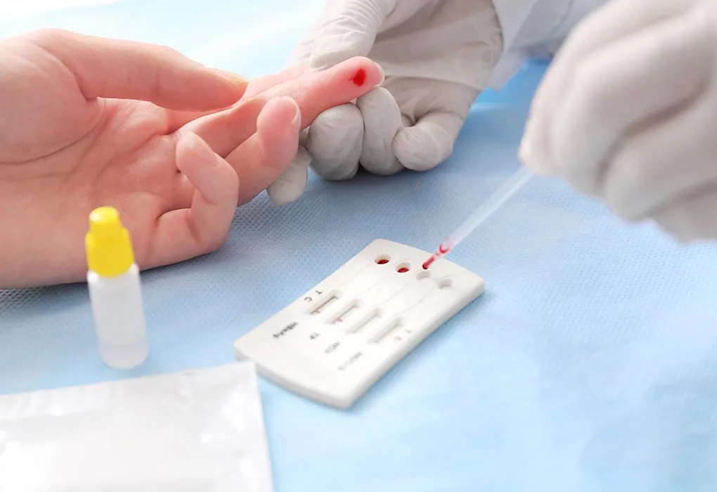 A doctor doing a hepatitis test on a woman