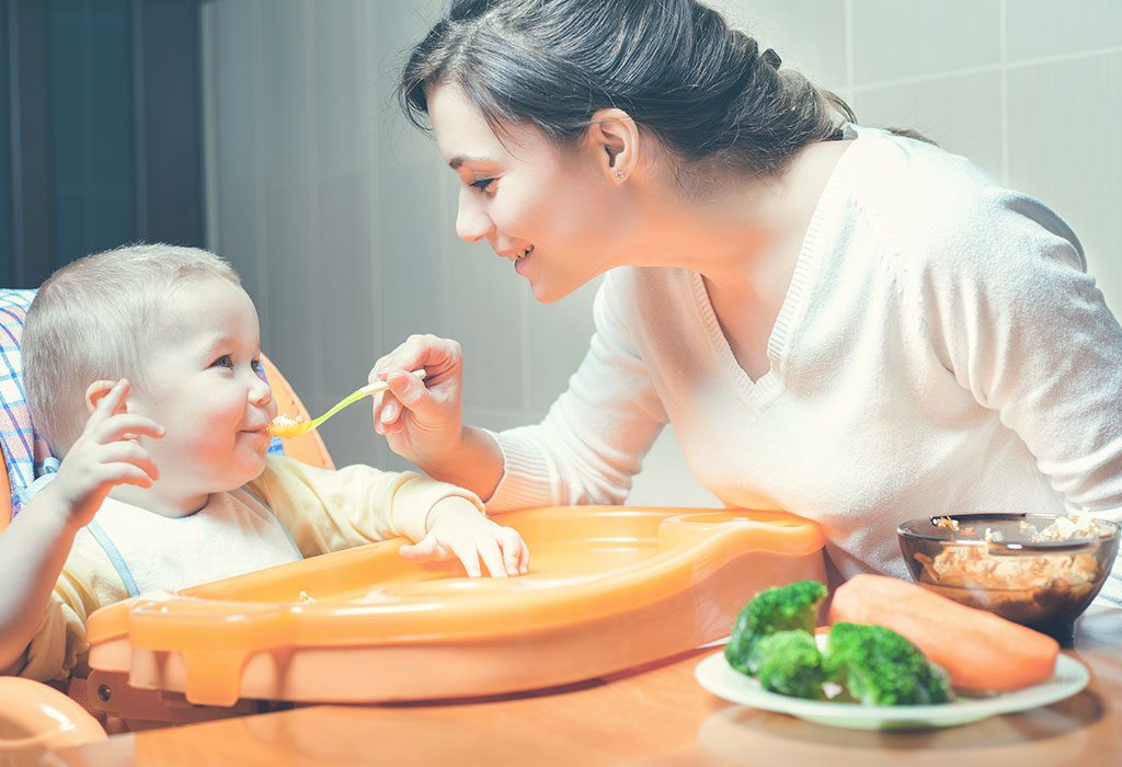 Mom feeds baby healthy food