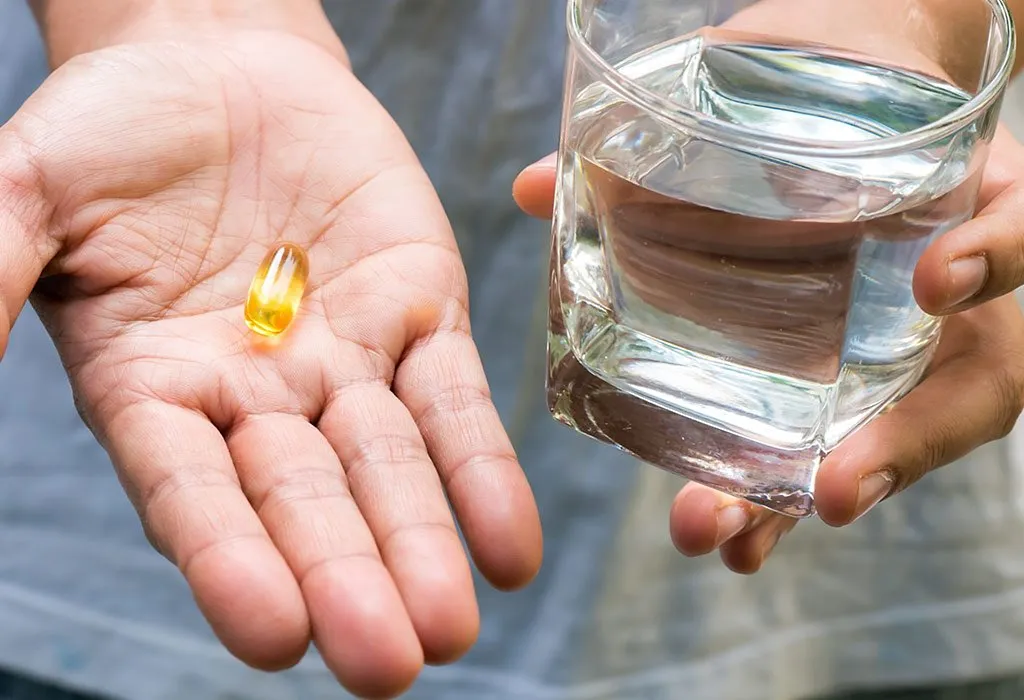 A woman with primrose oil capsule in her palm