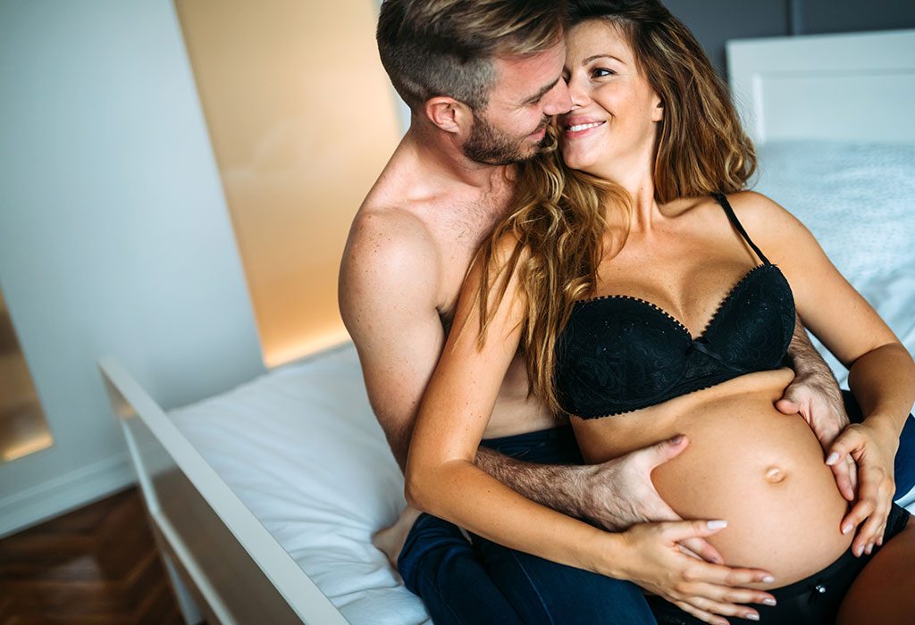 Pregnant woman with the husband getting romantic