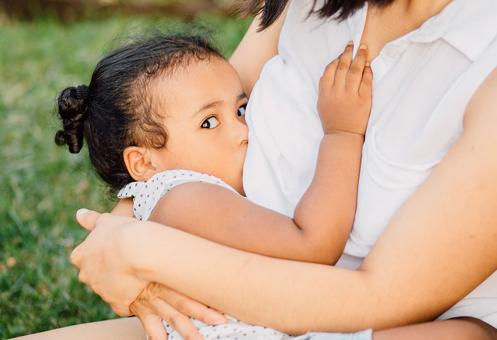 Madre amamantando cómodamente a su hija pequeña