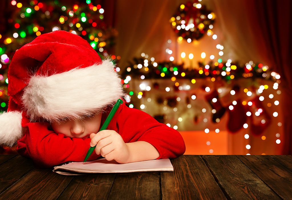 A kid dressed as Santa Claus writes a letter