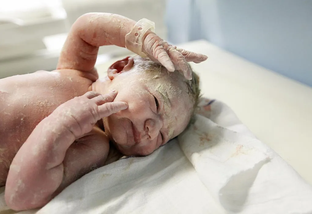 A baby covered in vernix