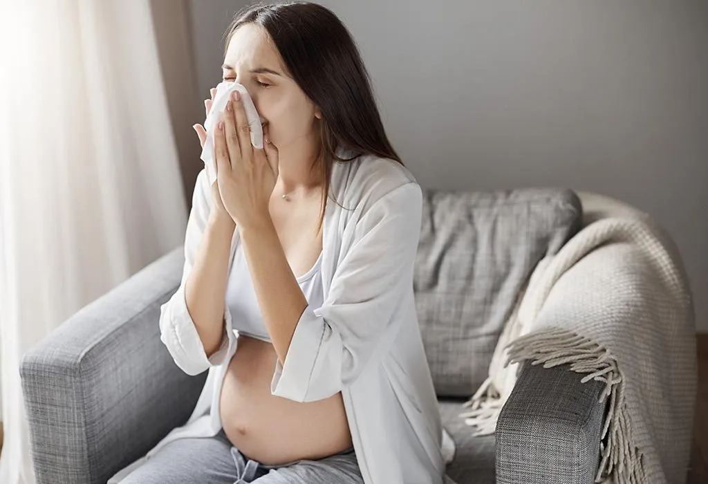 A pregnant woman coughing