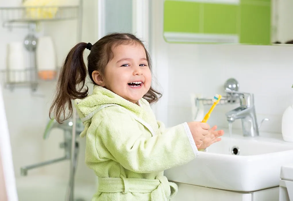 Girl brushing her own teeth