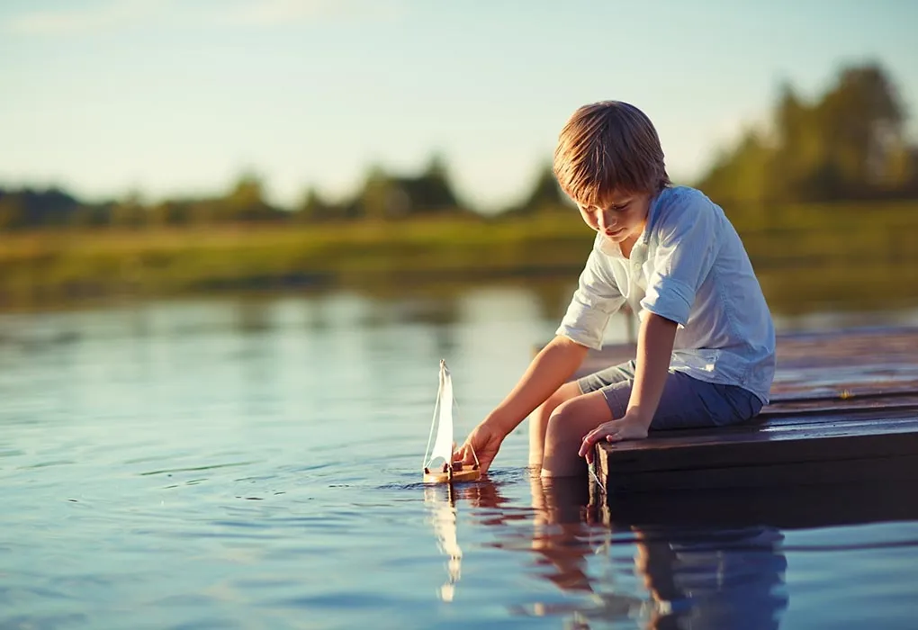 Boy playing with a toy-boat