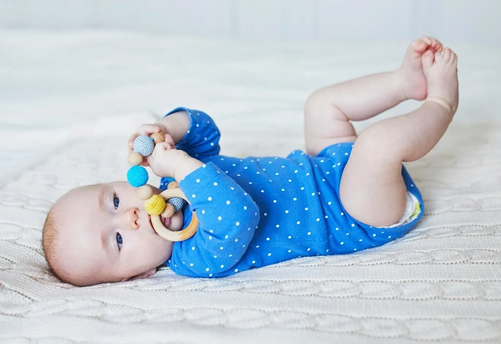4-month-old holding toys