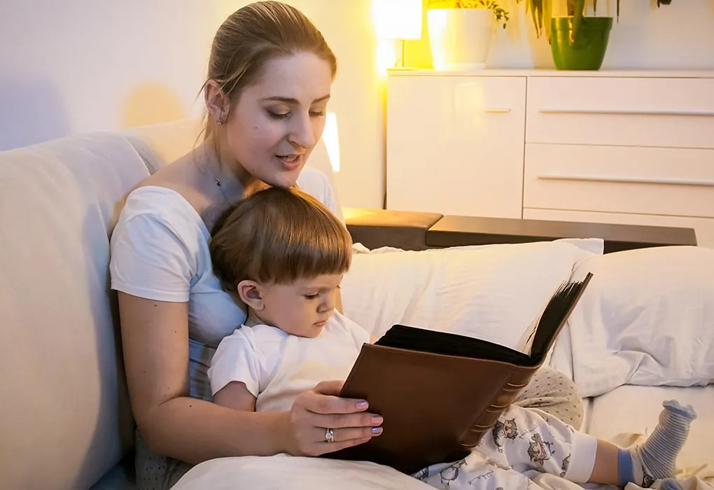 A mother reads a bedtime story to her son