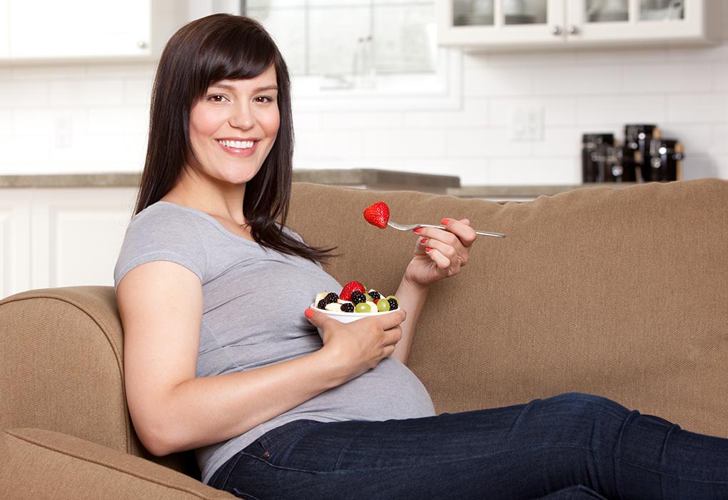 A pregnant woman eating fibrous fruits