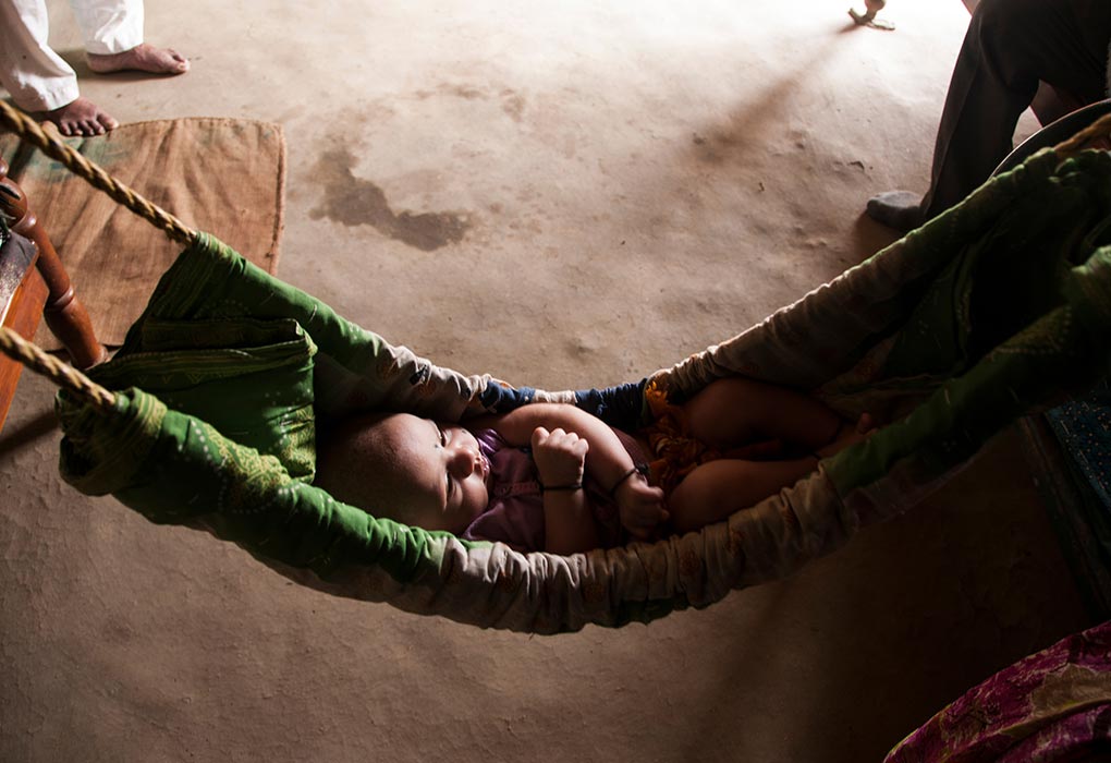 baby sleeping in swing chair