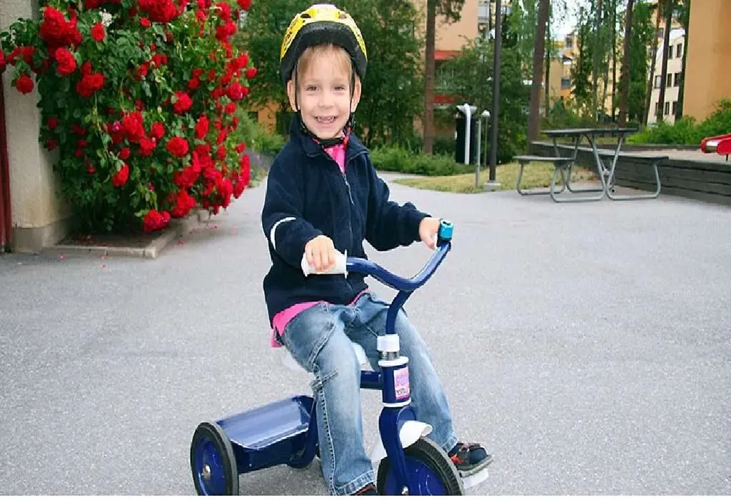 Boy riding tricycle on sale