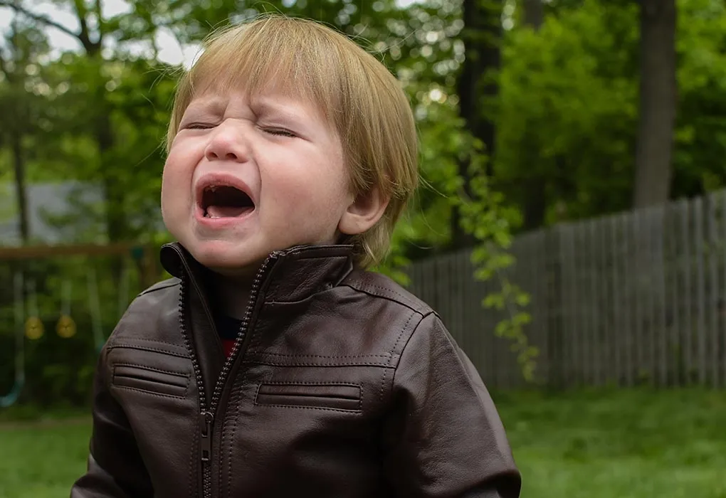 A baby boy whining