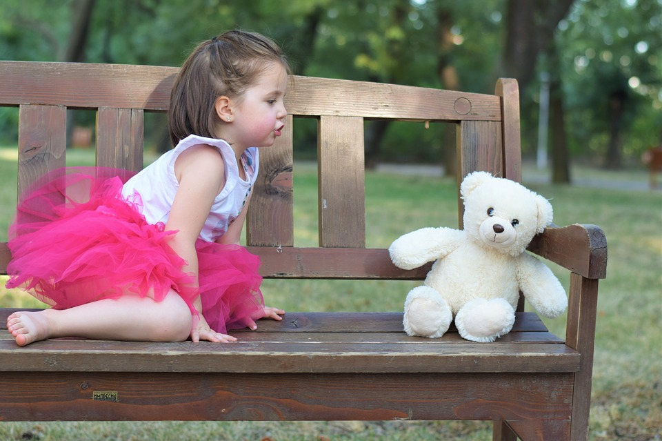 girl talking to teddy