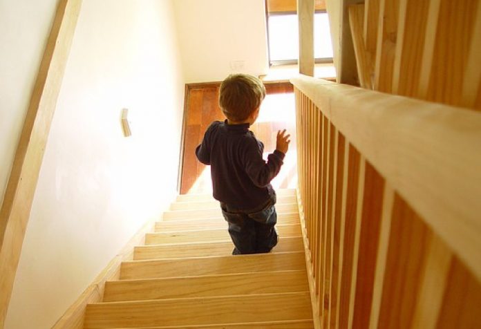 helping toddler walk up the stairs