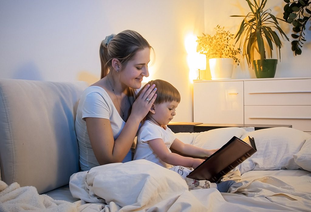 A mother reading to her child before making him sleep