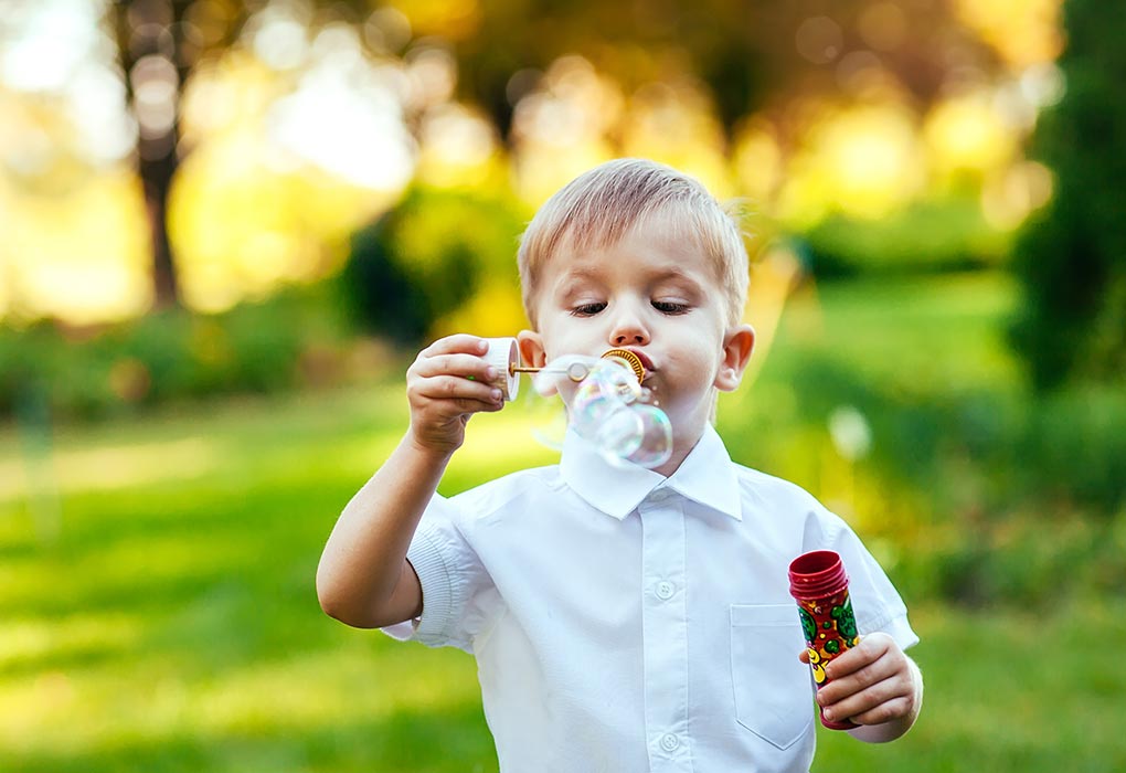 A kid blowing bubbles
