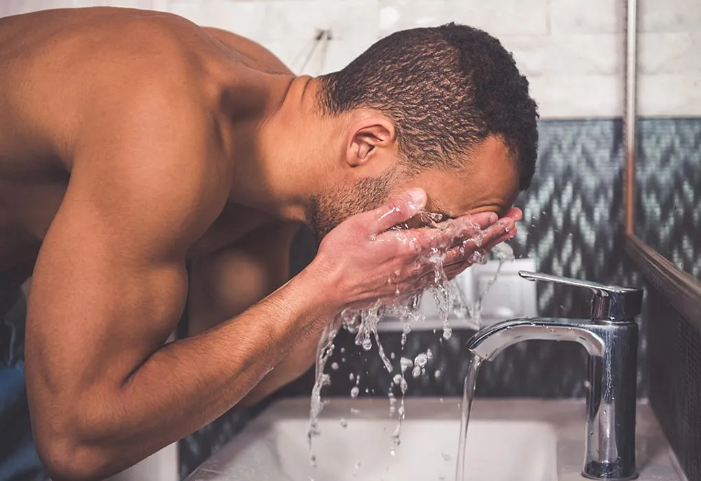 Man washing his face