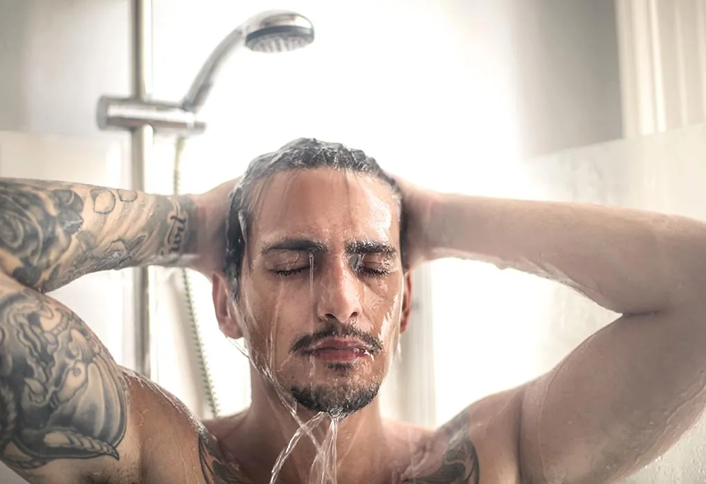 Handsome man taking a bath