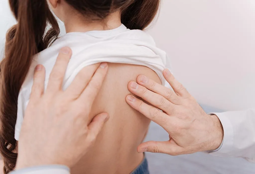 Checking for signs of scoliosis