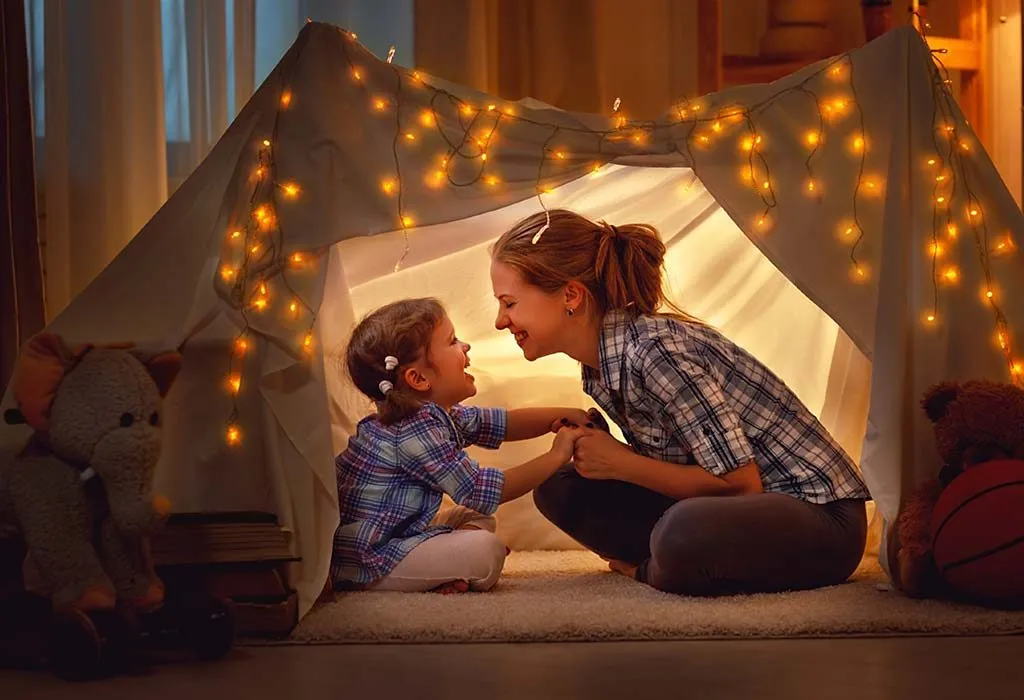 Mother and daughter enjoying a good time in a tent