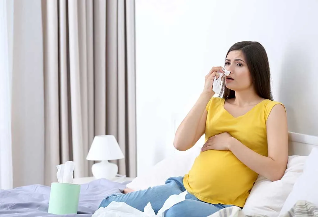 A pregnant woman coughing