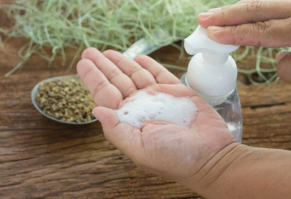 A woman using a hand sanitiser
