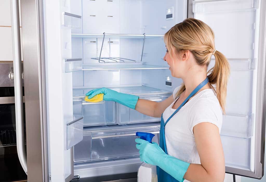 A woman cleaning her refrigerator