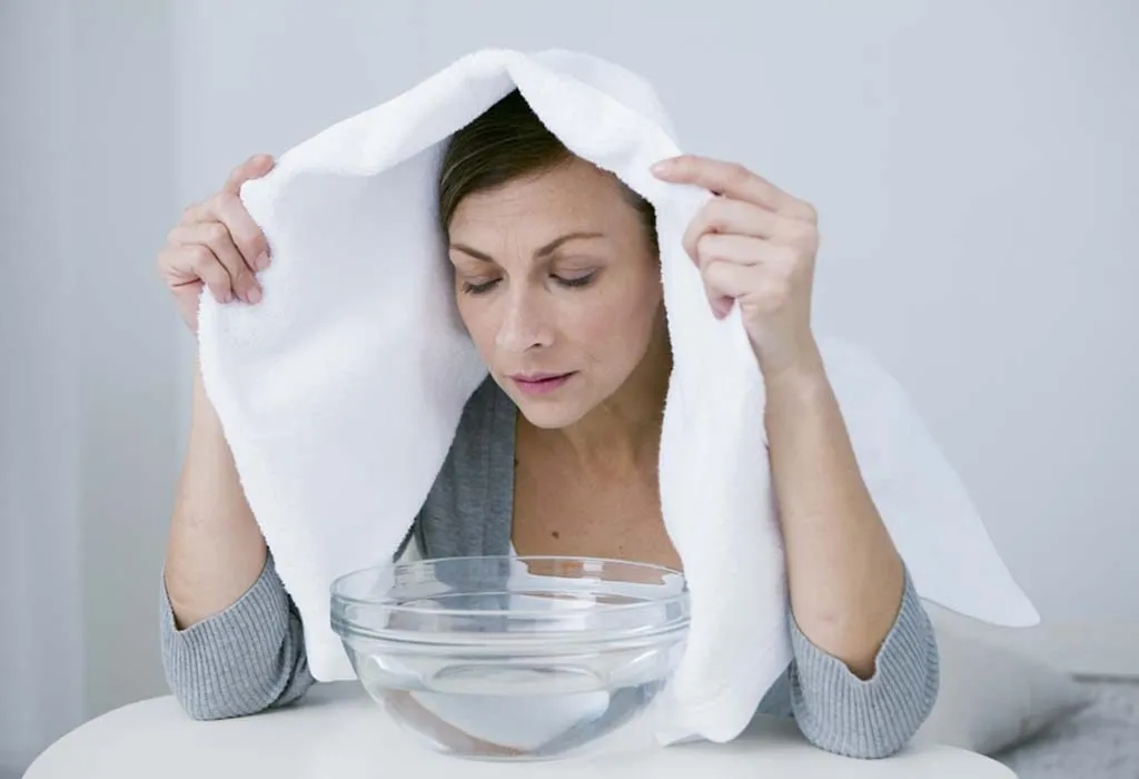 Woman inhaling steam to treat cold