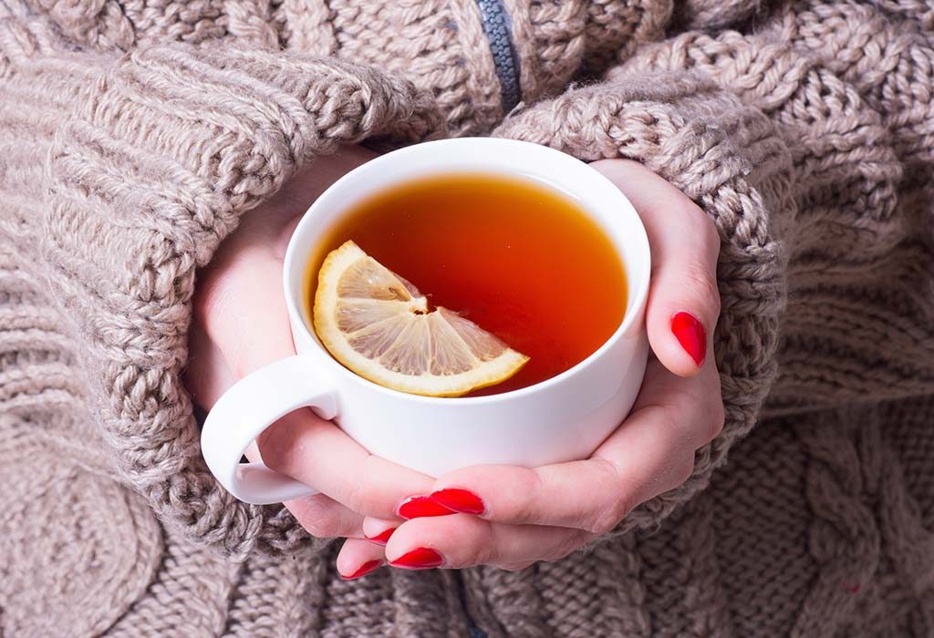 Woman holding lemon tea - common winter remedy