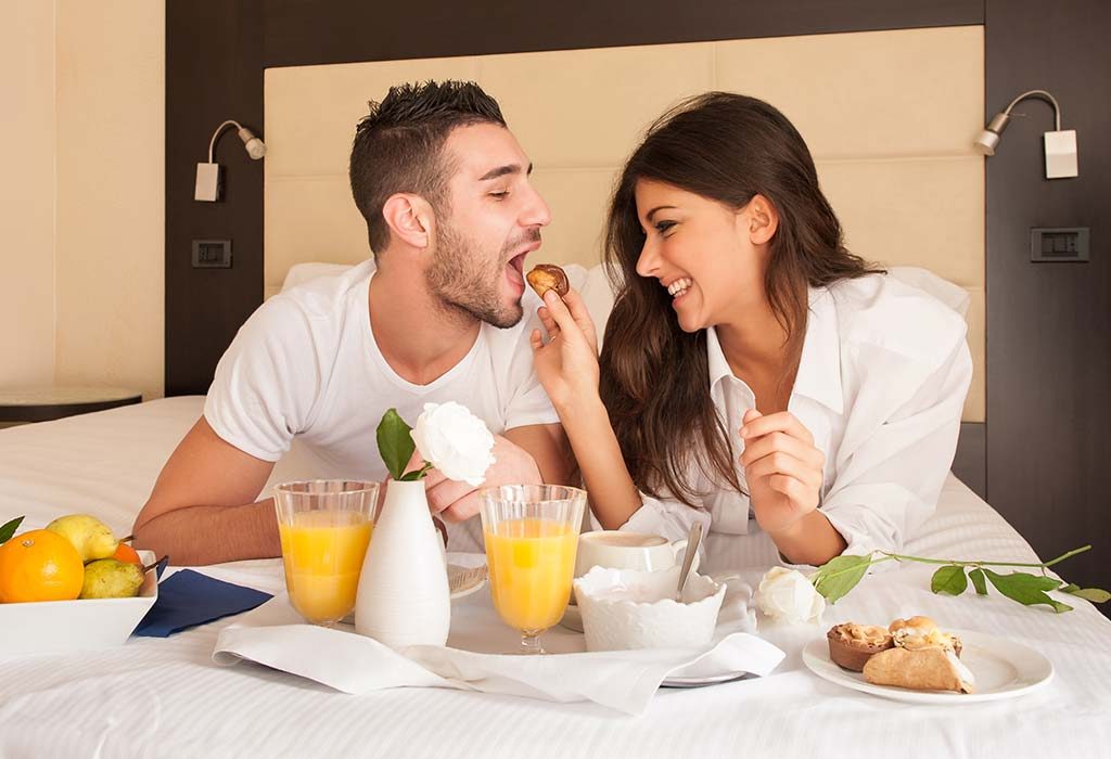 A couple having breakfast in bed