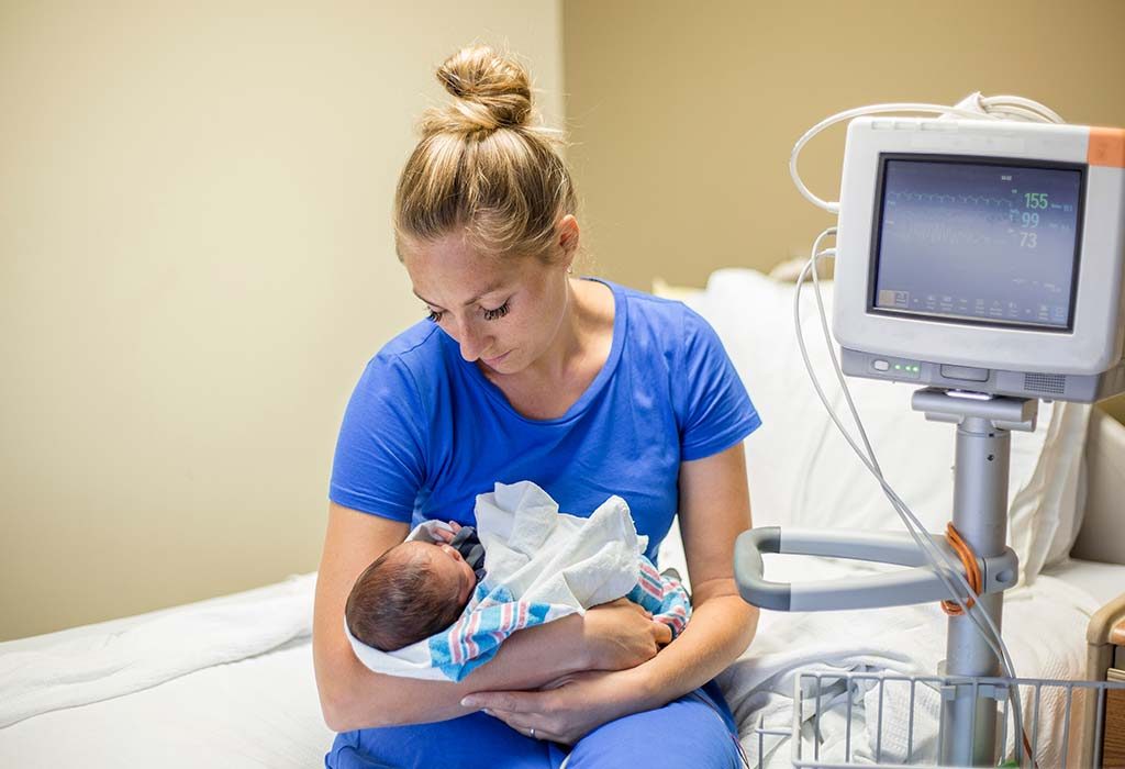 A new mother holding her premature baby in her arms