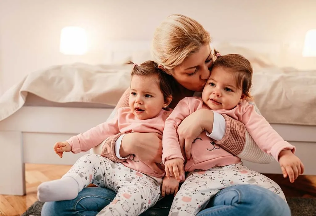 A mother holding her twins