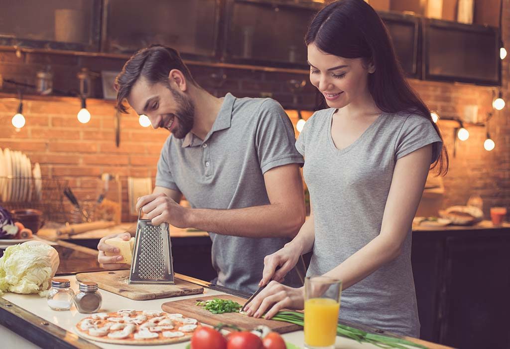 A man helping his wife in the kitchen