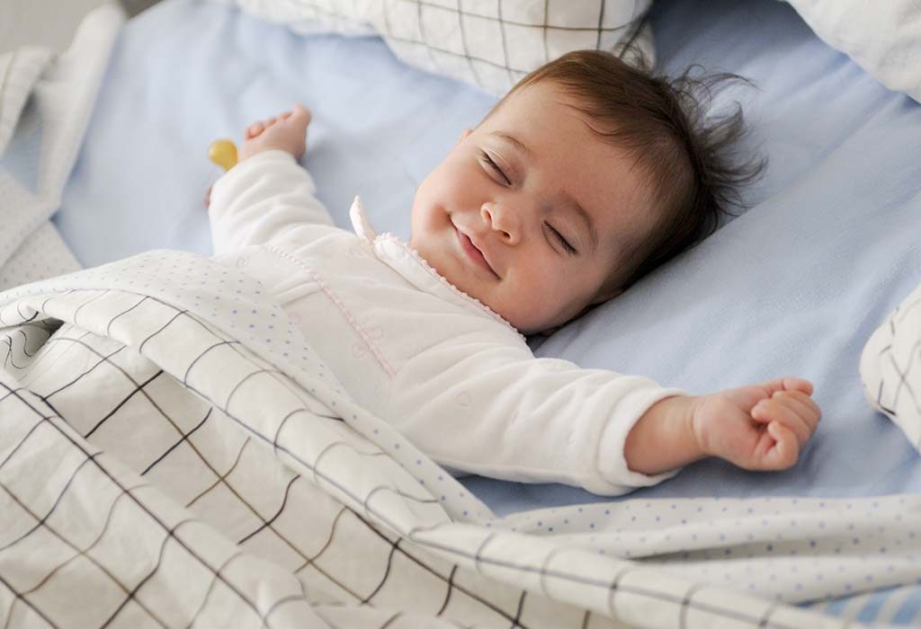 A baby sleeping comfortably in bed