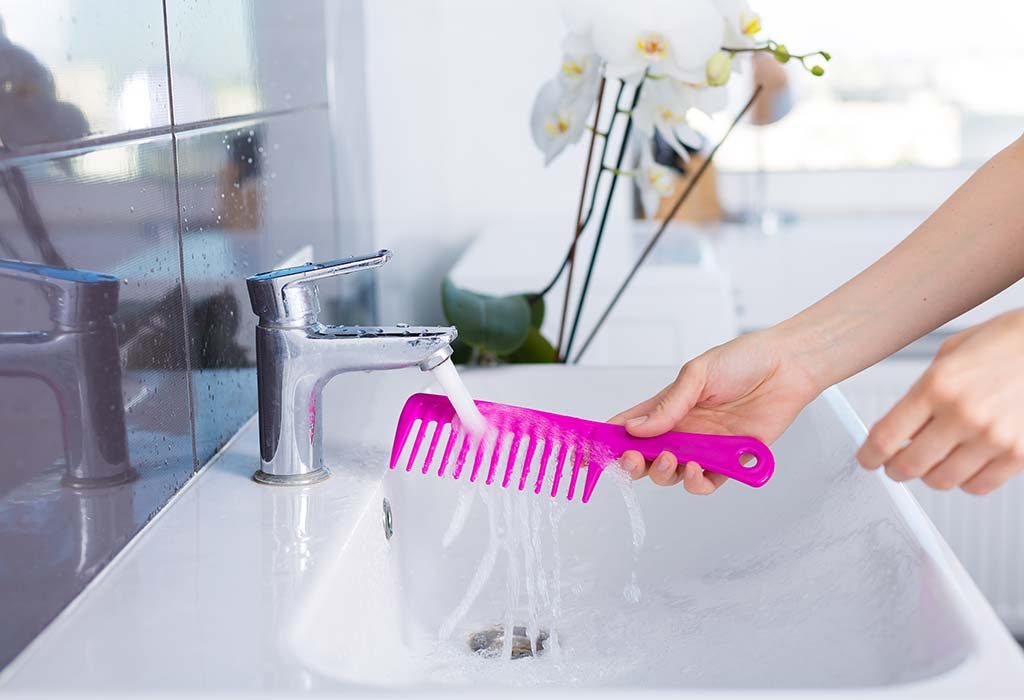 A woman rinses her comb