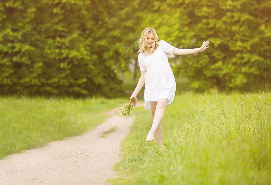 Happy Pregnant Woman Walking Barefoot
