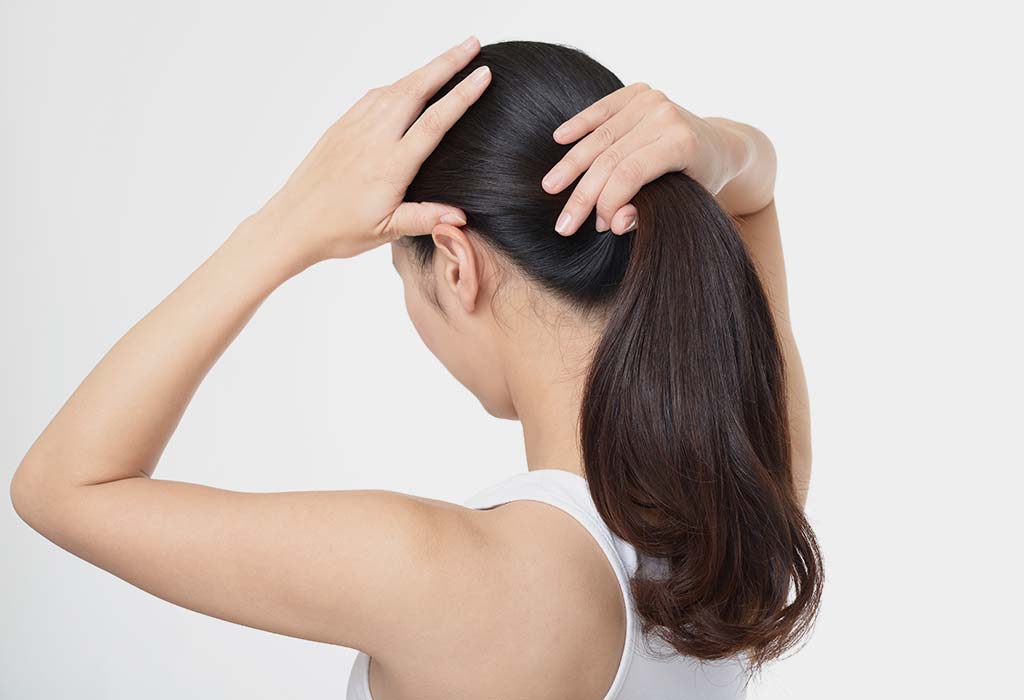 Woman Tying Ponytail