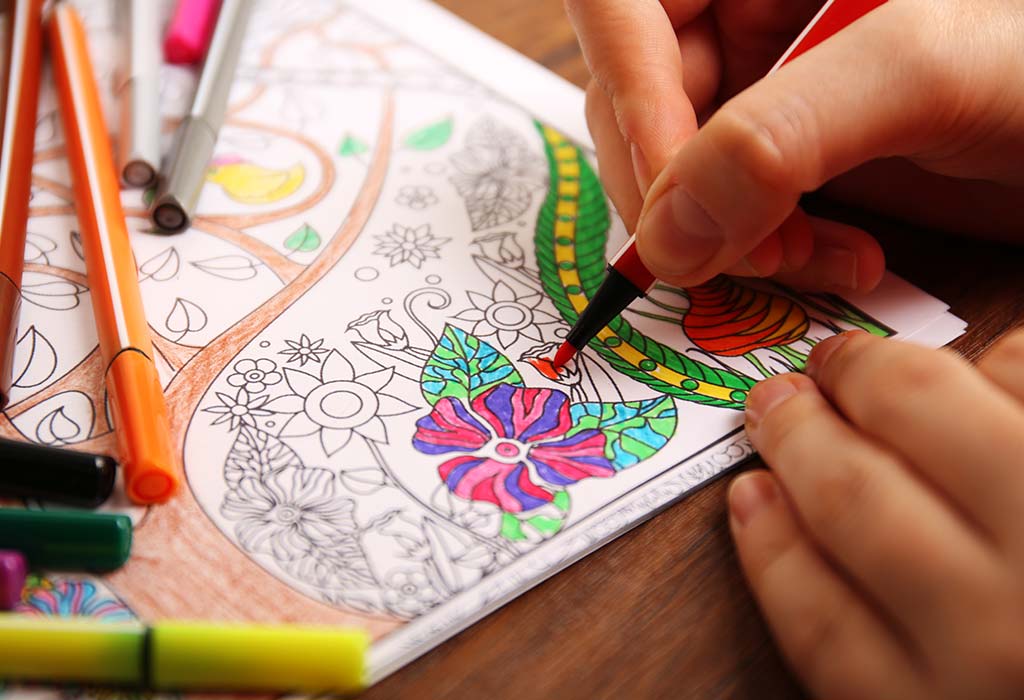 A woman colouring in a book
