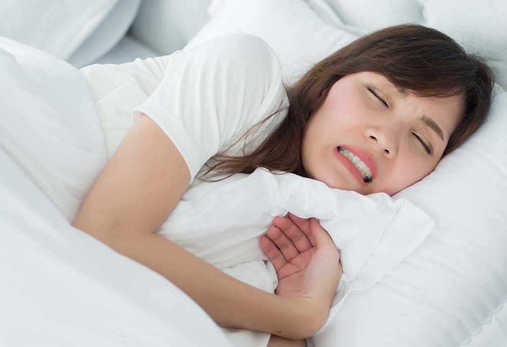 A woman grinding her teeth