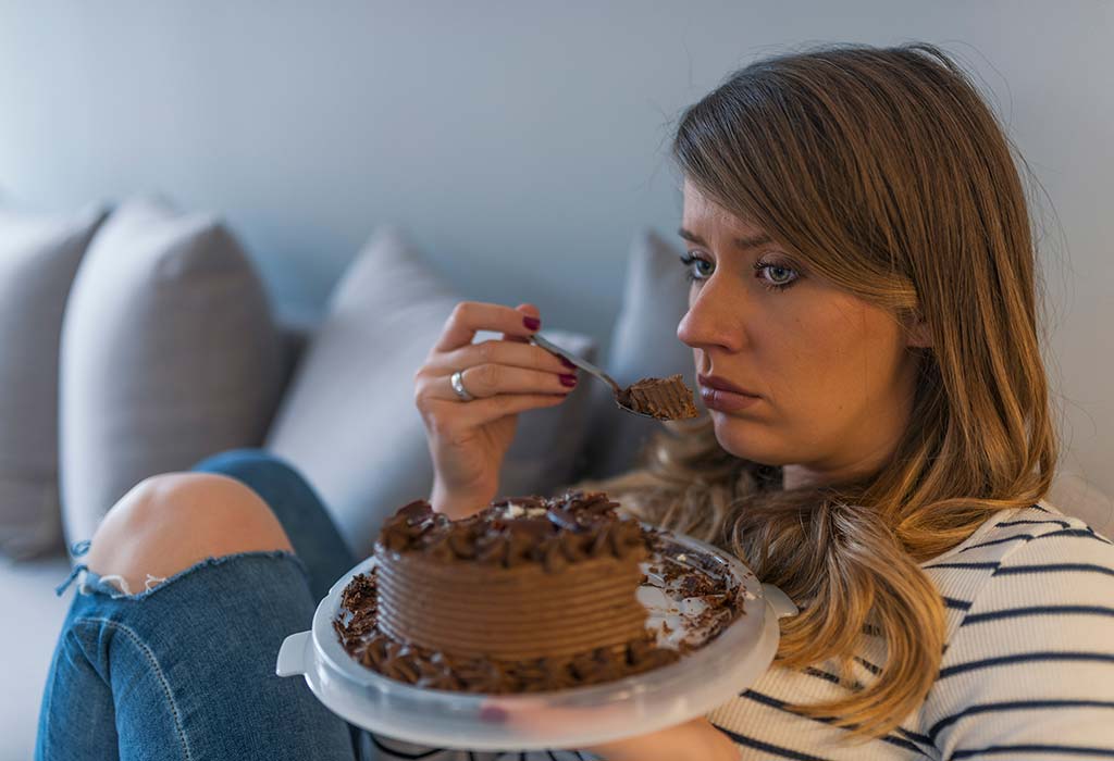 A woman eating a cake