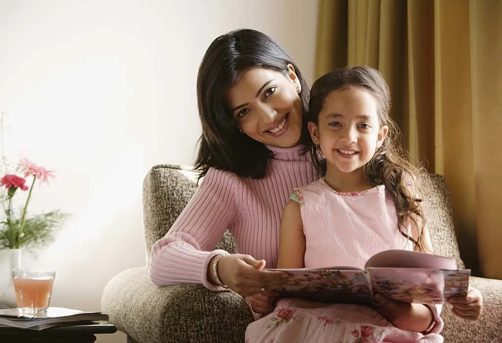 A mother reading out a book to her daughter