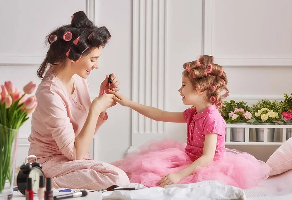 A mother and her daughter play dress up