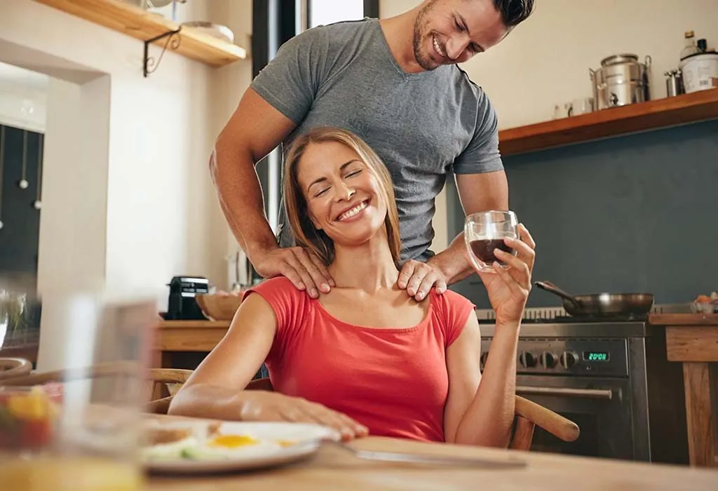 Husband massaging wife's shoulders