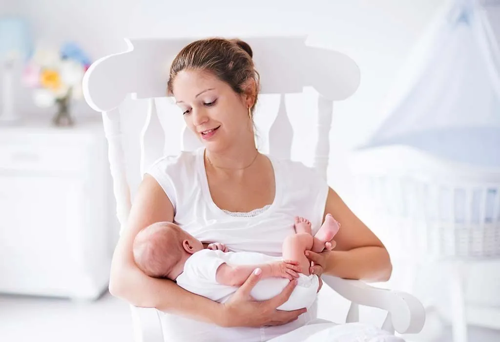 A mother rocking her baby