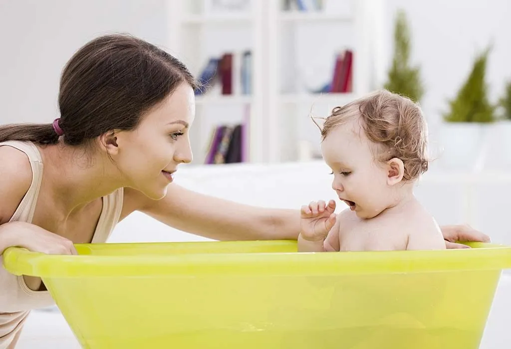 A mother bathing her baby